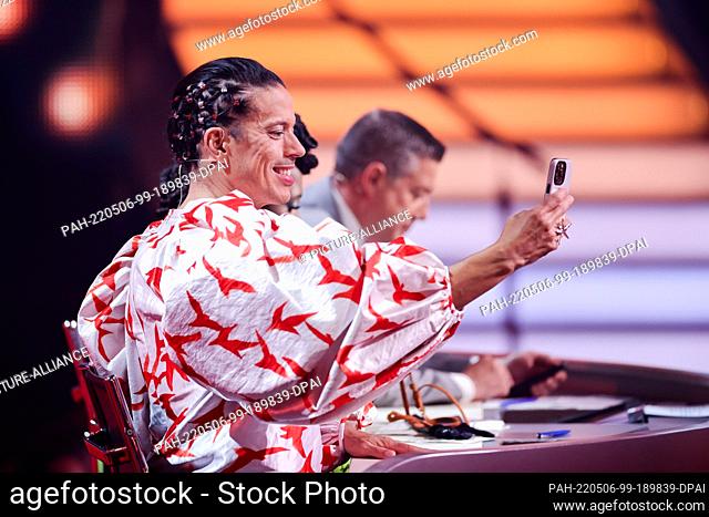 06 May 2022, North Rhine-Westphalia, Cologne: Jorge Gonzalez, jury member, speaks into his cell phone on the RTL dance show ""Let's Dance"" at the Coloneum