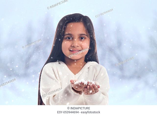 Little girl catching snow