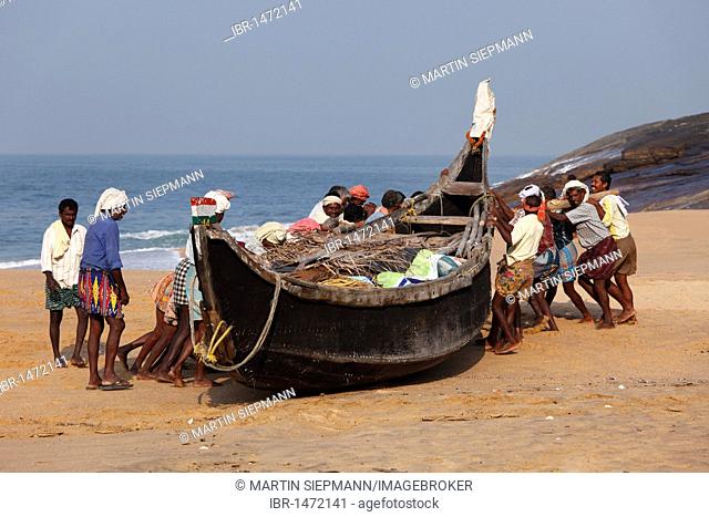 Fishermen pulling their boat on a beach south of Kovalam, Malabar Coast, Malabar, Kerala, southern India, India, Asia