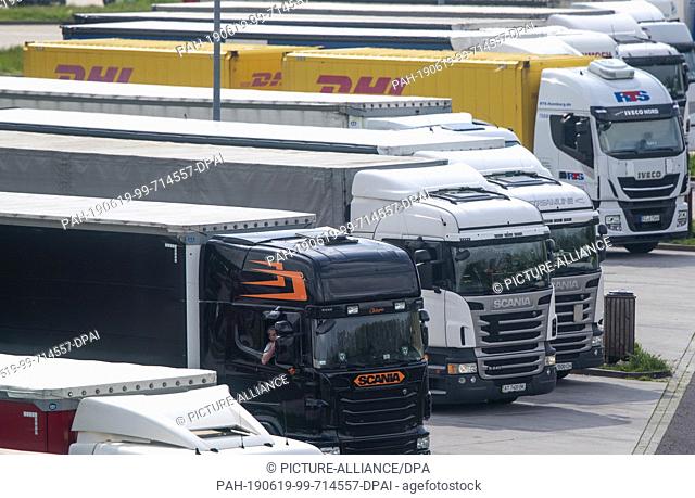 31 May 2019, Saxony-Anhalt, Marienborn: Trucks are parked on the parking lot of the service area next to the memorial of the German division Marienborn