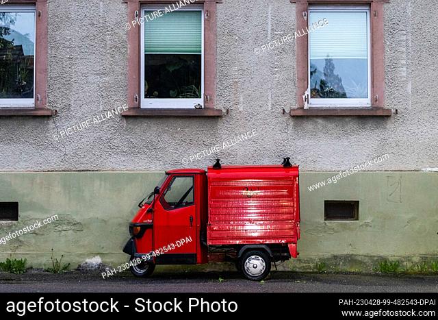 28 April 2023, Baden-Württemberg, Freiburg: A red Piaggio ""Ape"" is parked in front of a house. Photo: Philipp von Ditfurth/dpa