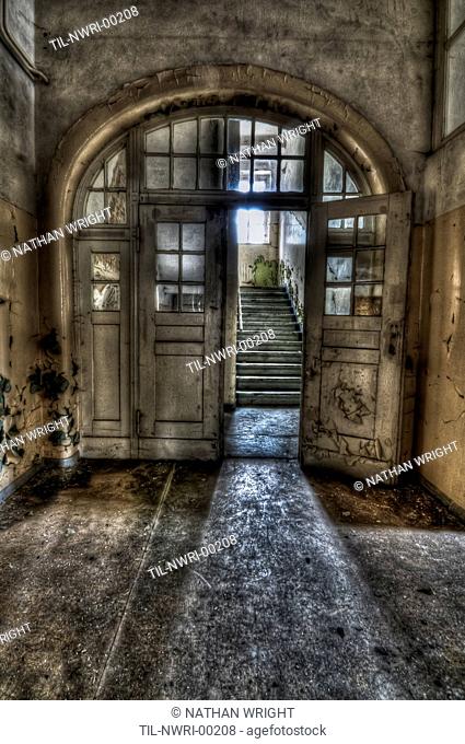 Abandoned lunatic asylum north of Berlin, Germany Open doorway leading to stairs