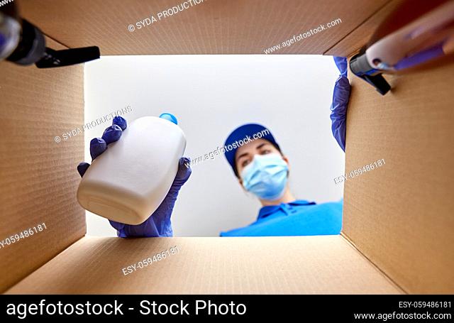 woman in mask packing parcel box with cosmetics
