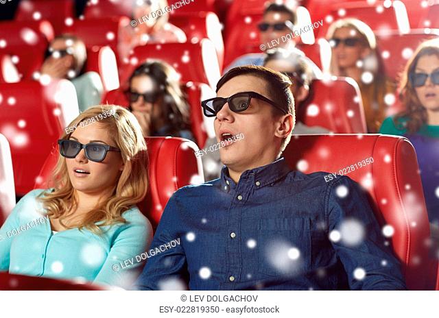 cinema, technology, entertainment and people concept - scared friends or couple with 3d glasses watching horror or thriller movie in theater with snowflakes