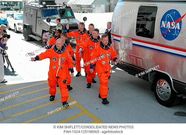 FILE: In this photo released by NASA, waving flags for the Fourth of July, the STS-121 crew heads for the Astrovan and the ride to Launch Pad 39B at the Kennedy...