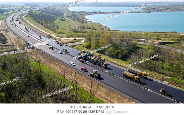 17 April 2019, Saxony, Espenhain: Two asphalt pavers are used to lay the surface course on the new A72 (taken with a drone)