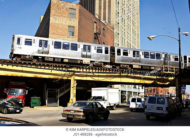 Illinois. Chicago. El train pass over busy city street, Bucktown neighborhood on near west side of city, Wicker Park