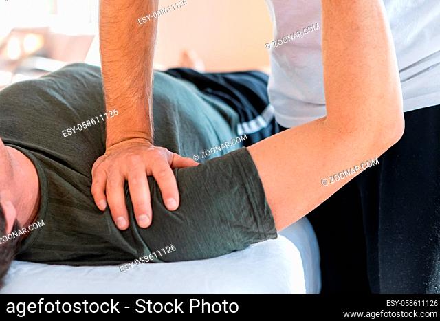 A man receiving a massage. Cropped image of a professional massage therapist working on a sportsman hand. A male receiving hand massage