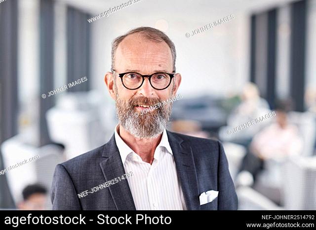 Portrait of businessman looking at camera
