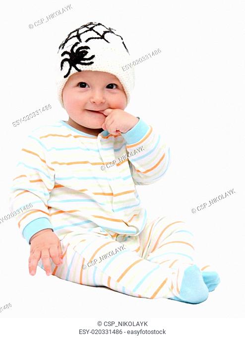 beautiful baby boy with knitted hat sitting