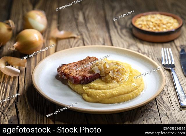 Czech cuisine, smoked meat with pea porridge and fried onion until golden