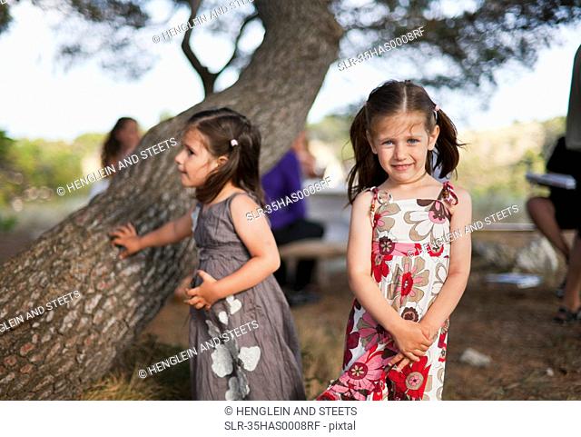 Girls playing by tree outdoors