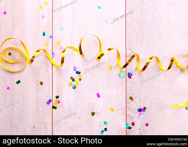 Wooden board with colorful streamers