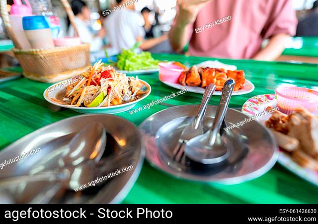 Spicy green papaya salad or Som Tum with Thai rice noodles. Street food with hot and spicy dish in Thailand. The famous local Thai street food