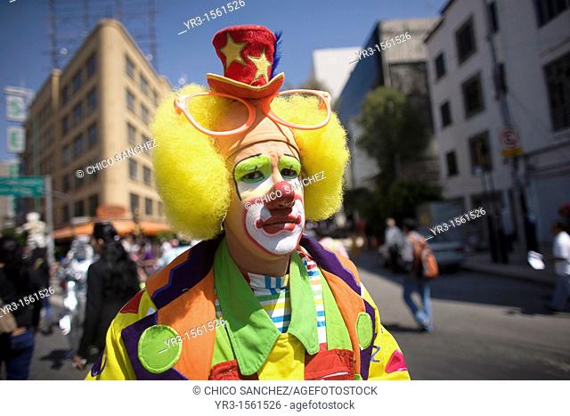 A clown walks in a parade during the 16th International Clown Convention: The Laughter Fair organized by the Latino Clown Brotherhood, in Mexico City