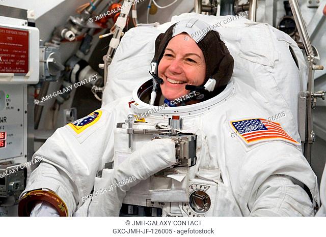 NASA astronaut Catherine Coleman, Expedition 2627 flight engineer, participates in an Extravehicular Mobility Unit (EMU) spacesuit fit check in the Space...