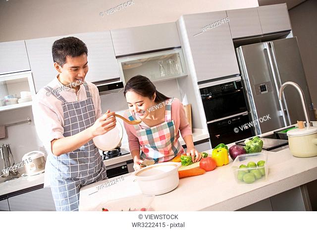 The young couple soup in the kitchen