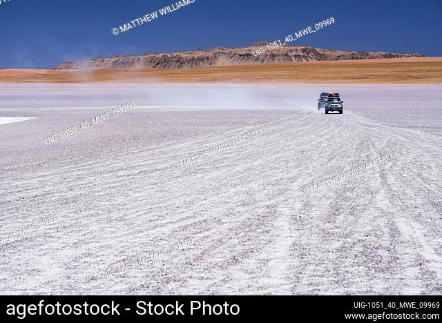 Driving on a salt flats area by Laguna Hedionda, a salt lake in the Altiplano of Bolivia