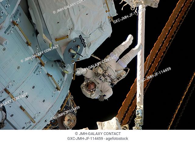 NASA astronaut Nicholas Patrick, STS-130 mission specialist, participates in the mission's third and final session of extravehicular activity (EVA) as...