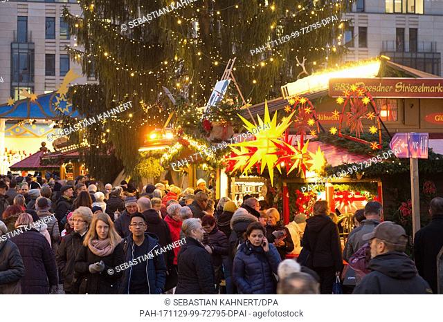 Visitors walk past the stands on the illuminated Striezel Market in Dresden, Germany, 29 November 2017. The Christmas market on the Old Market Square in Dresden...