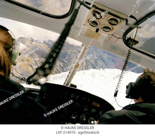 Rea view of two pilots inside a helicopter, Franz Josef and Fox Glaciers, Westland National Park, west coast, South Island, New Zealand