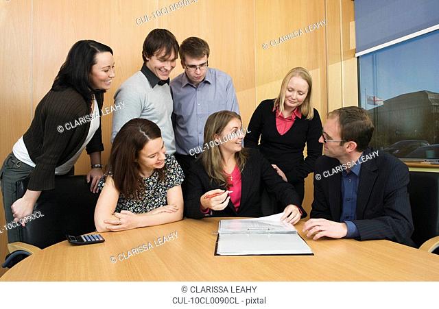Colleagues having meeting in boardroom