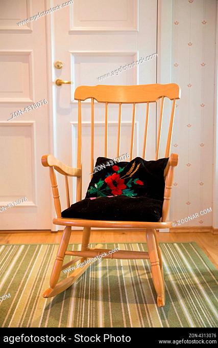 One warmished turned rocking chair at cozy room