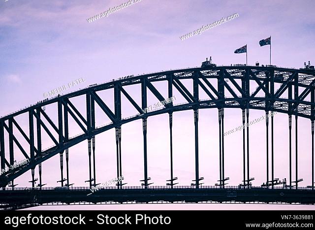 Climbers walking to the summit on the arch of the Sydney Harbour Bridge, Sydney, New South Wales, Australia