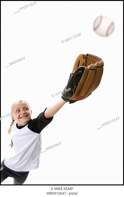 Girl catching a baseball in glove