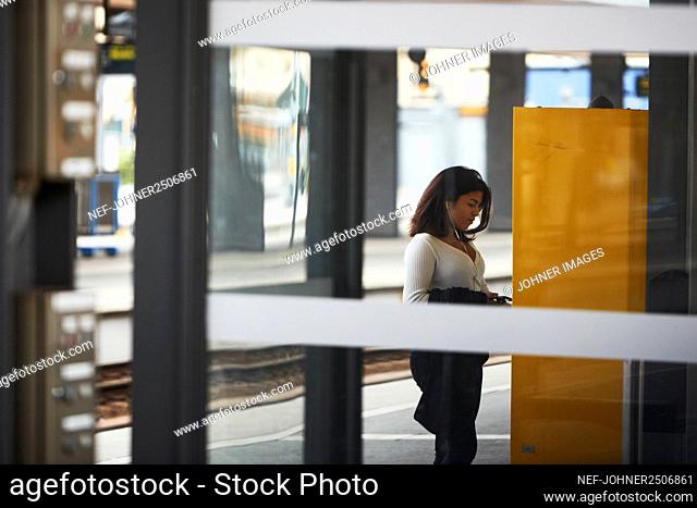 Woman using ticket machine