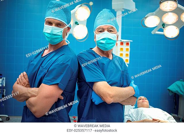 Portrait of male surgeons standing in operation theater