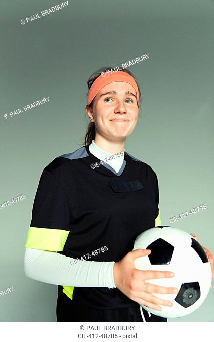 Confident teenage girl soccer player