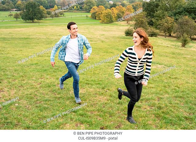 Couple running in field