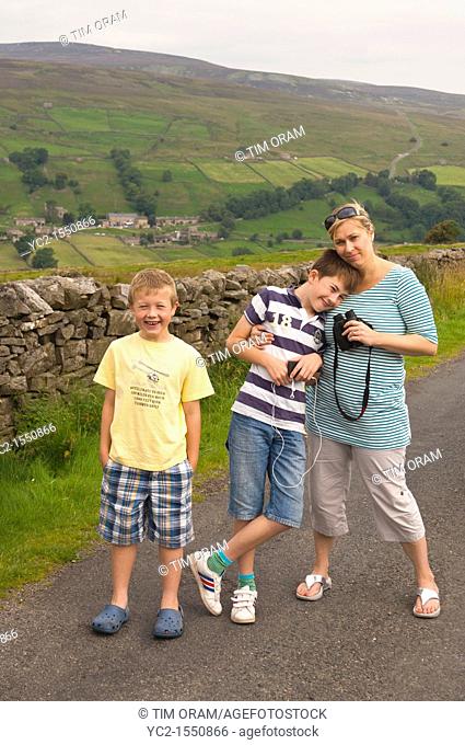 A mum with her two sons in Swaledale in North Yorkshire , England , Britain , Uk
