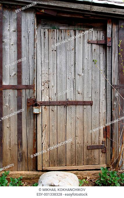 closed wooden door of old shed