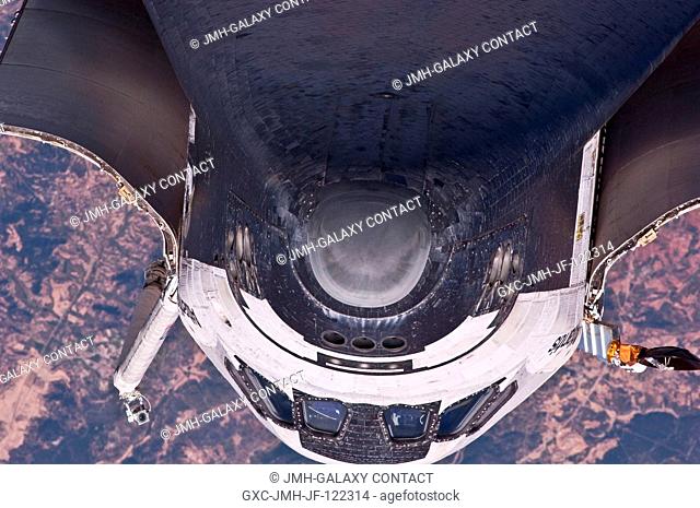 This view of the underside of the crew cabin of the space shuttle Atlantis was provided by an Expedition 23 crew member during a survey of the approaching...