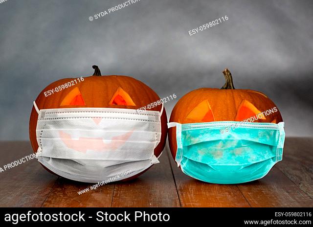 carved pumpkins or jack-o-lanterns in masks