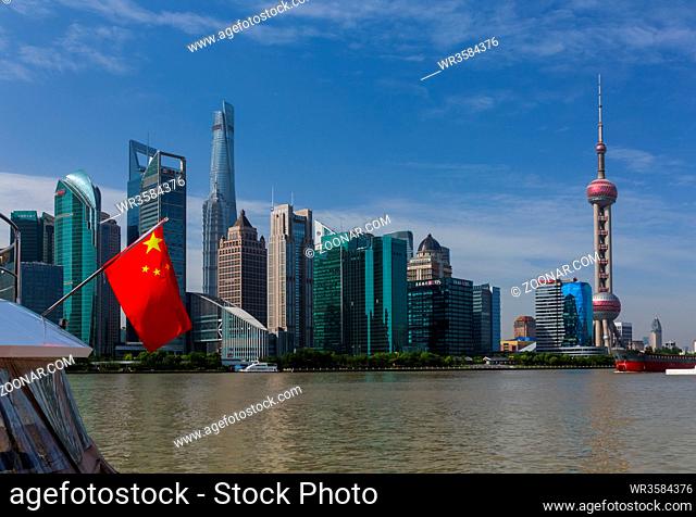 Shanghai, China - May 23, 2018: Chinese flag and modern Pudong skyline in Shanghai, China