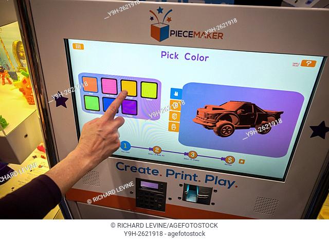 A Piecemaker Technologies 3d printer kiosk prints a Ford F-150 pick-up truck model at the 113th North American International Toy Fair in the Jacob Javits...