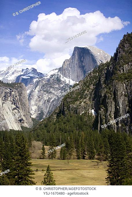 Half Dome and Yosemite valley under blue sky and clouds