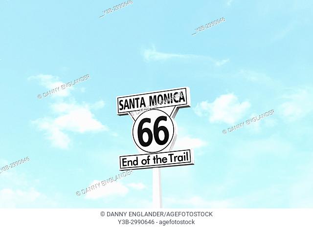 Minimalist scene of the Route 66 End of the Trail sign on Santa Monica Pier in California