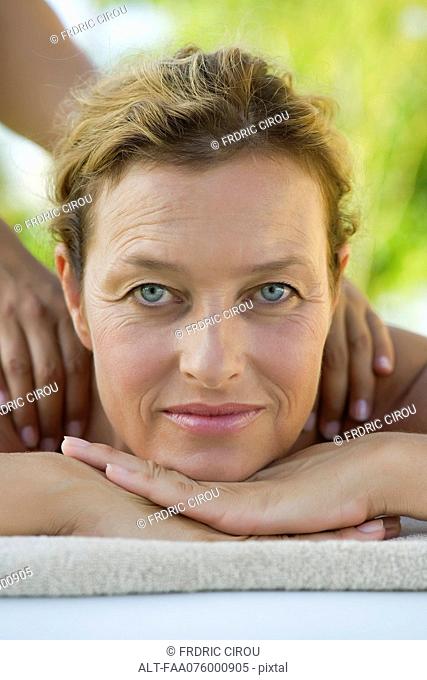 Mature woman getting massage, portrait