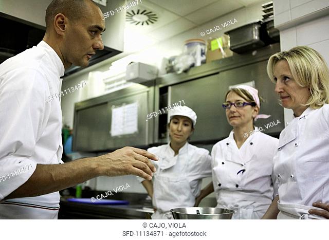 A chef giving staff instructions