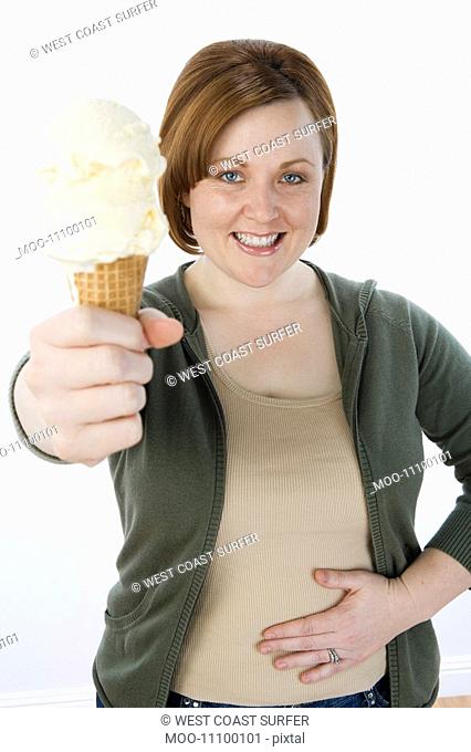 Mid-adult woman holding ice cream cone portrait