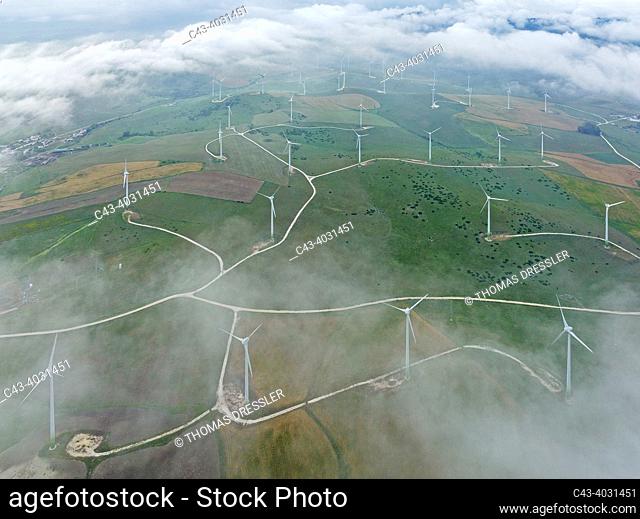 Windmills on a wind farm near Zahara de los Atunes. At a cloudy morning. Aerial view. Drone shot. Cádiz province, Andalusia, Spain