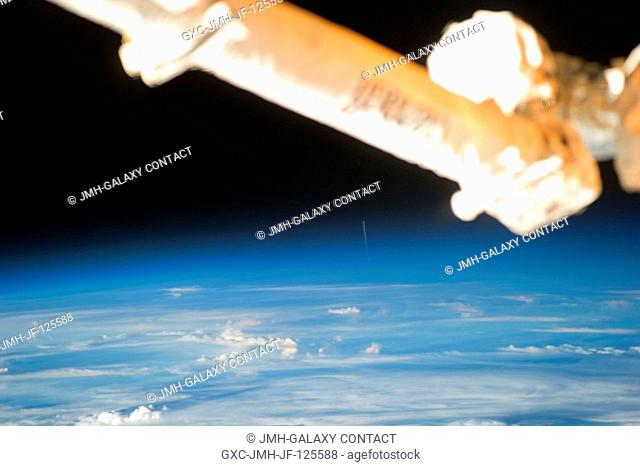 The Expedition 26 crew member aboard the International Space Station who snapped this photograph of the Ariane 5 rocket, barely visible in the far background