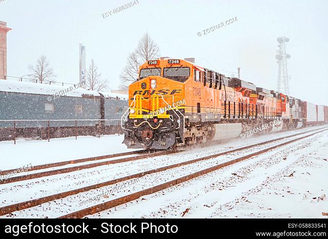 Fargo, USA - March 7 2011: A BNSF freight train passes thru Fargo in a snow storm in North Dakota, USA