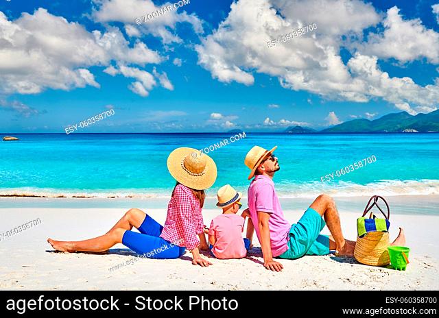Family on beautiful Anse Soleil beach, young couple with three year old toddler boy. Summer vacation at Seychelles, Mahe