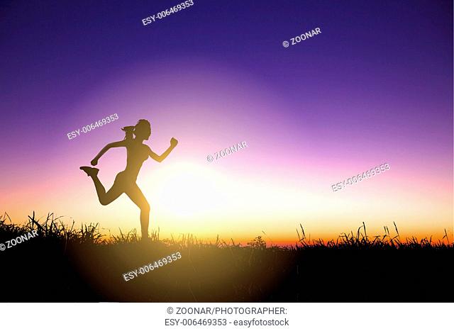 Silhouette of woman running alone at beautiful sun