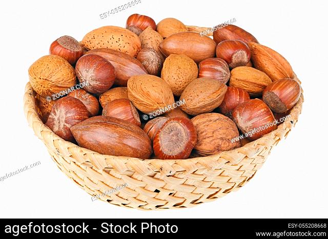 Wicker basket with hazelnuts walnuts almonds and pecan nuts for Christmas table
